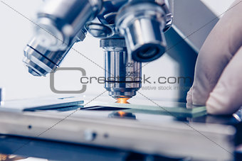 Scientist hands with microscope
