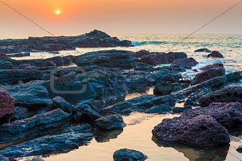 beautiful seascape and rocky shore at sunset