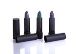Set of modern lipsticks in gray, green and purple colors  