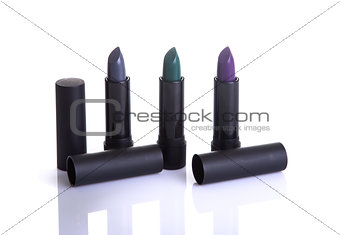 Set of modern lipsticks in gray, green and purple colors  