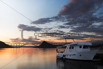 Kirk bridge with ship at sunset, Croatia