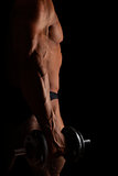 Sport and Fitness. Sexy bodybuilder holding dumbbell isolated on