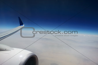Looking through window aircraft, flying over Iraq.  View from airplane. 