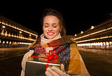 Woman looking on Christmas gift box on Piazza San Marco, Venice