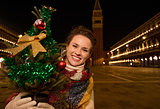Woman with Christmas tree standing on Piazza San Marco in Venice