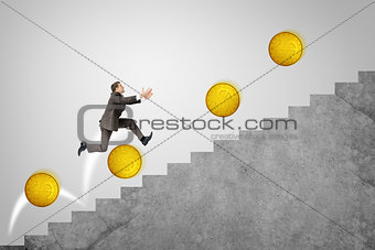 Businessman running up stairs with gold coins