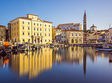 Buildings of Piran Old Town Reflected in Water.