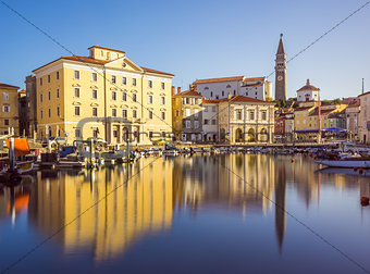 Buildings of Piran Old Town Reflected in Water.