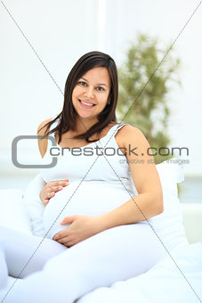 Pregnant woman lying on the bed