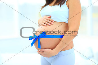 woman holds her baby bump,