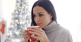 Woman enjoying a cup of Christmas coffee