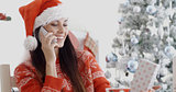 Young woman making a Christmas greeting call