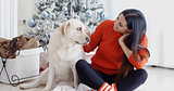 Young woman and her dog celebrating Christmas