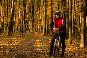 Biker on the forest road riding outdoor