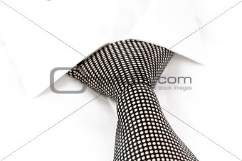 black and white spotted tie knotted Windsor