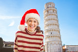 Portrait of woman in Santa hat in front of Leaning Tour of Pisa