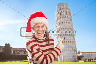 Smiling woman in Santa hat pointing on Leaning Tour of Pisa