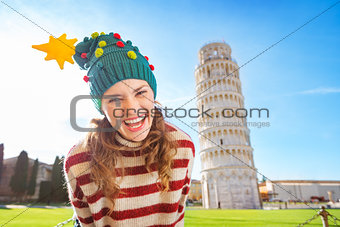 Merry woman in Christmas tree hat near Leaning Tour of Pisa