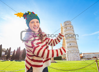Woman in Christmas tree hat supporting Leaning Tour of Pisa
