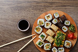 Sushi set at round wooden plate