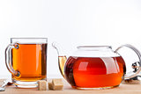 Teapot and cup of tea on wood table background.