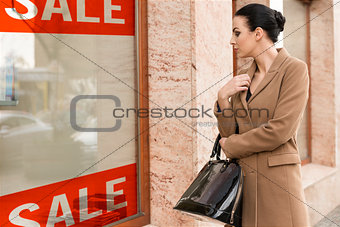 pretty girl near a shop window