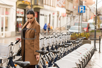 winter dressed woman near city bike
