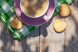 Coffee cup and cookies on garden table