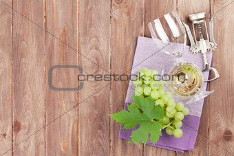 Bunch of grapes, white wine and corkscrew