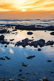beautiful mellow sunset over rocky beach