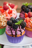 Delicious cupcake decorated with blueberry and blackberries