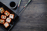 Sushi roll with chopsticks