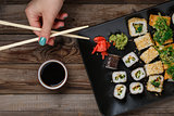 Sushi. Hand with chopsticks