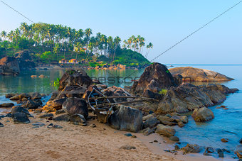 old boat in the rocks at the beach of Goa