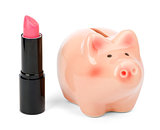 Lipstick with piggy bank on white