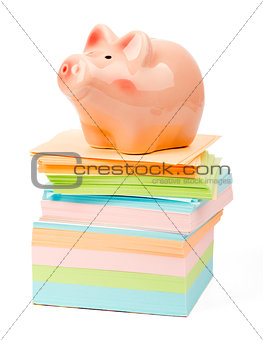 Piggy bank on pile of stickers