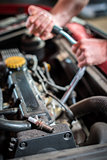 Starting ignition plug Car mechanic in auto repair service