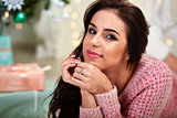 Portrait of attractive caucasian woman brunette, studio shot near  christmas tree