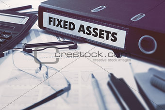 Fixed Assets on Ring Binder. Blured, Toned Image.