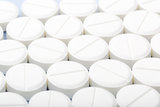 White pills on a white background