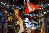 Woman with Christmas tree, gift and shopping bags in Venice