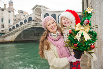 Mother and child in Santa Hat with Christmas tree in Venice