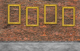 Golden frames on brick wall