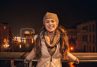 Portrait of woman standing on a bridge overlooking Grand canal