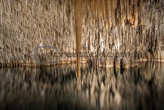 Cave with lake, stalactites and stalagmites, long exposure