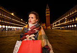 Modern woman in winter coat with standing on Piazza San Marco