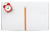 Open notebook with alarm clock