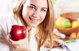 Happy woman eating apple