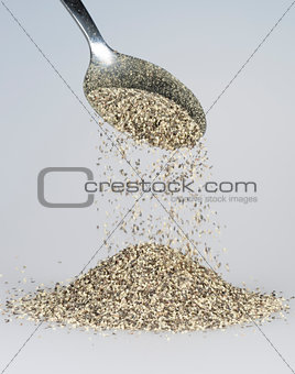 Black Pepper Falling from Tablespoon