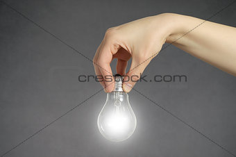 Hand with light bulb